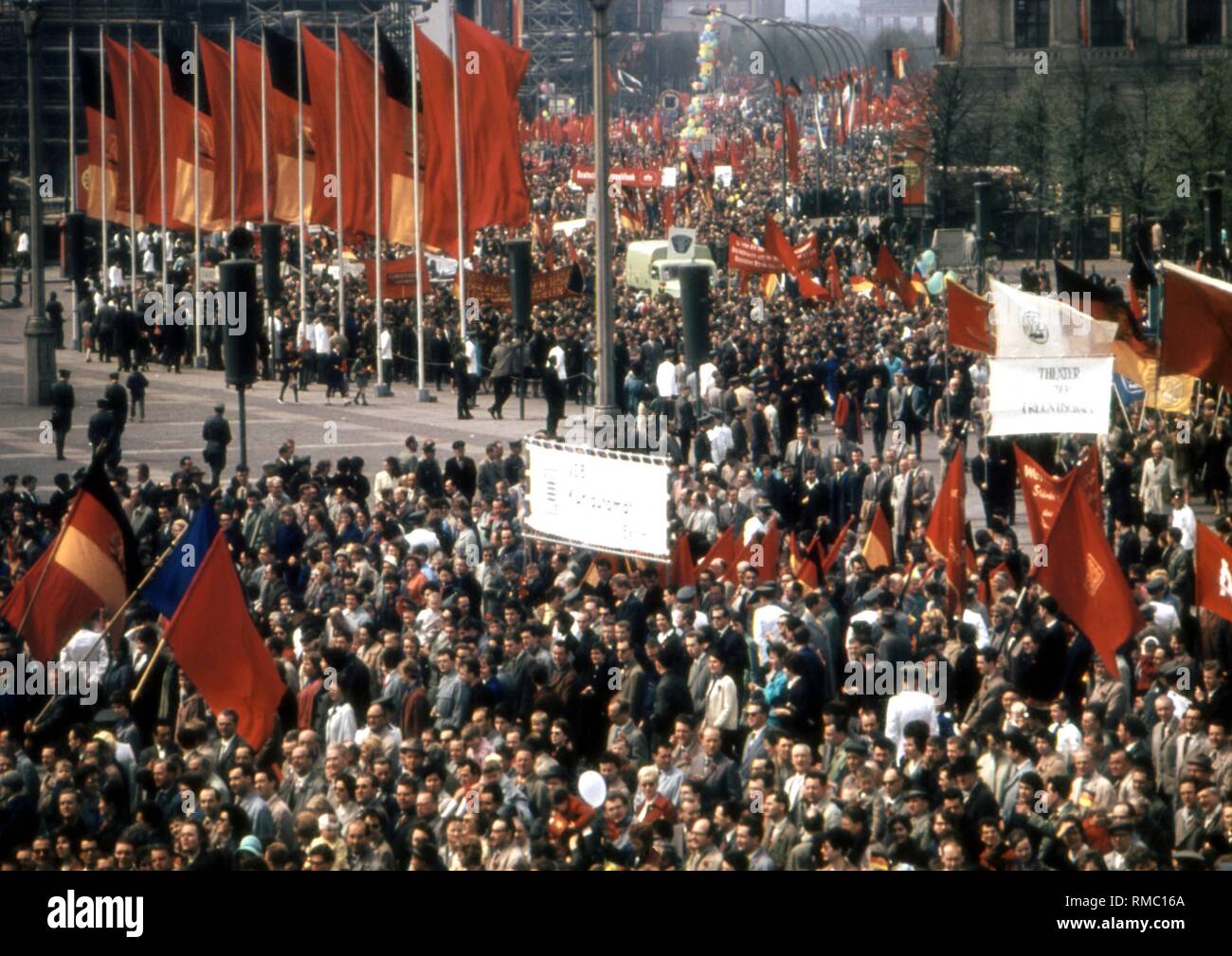 People with red flags participate in the rally on May 1, 1960 at Marx-Engels-Platz in East Berlin. Stock Photo