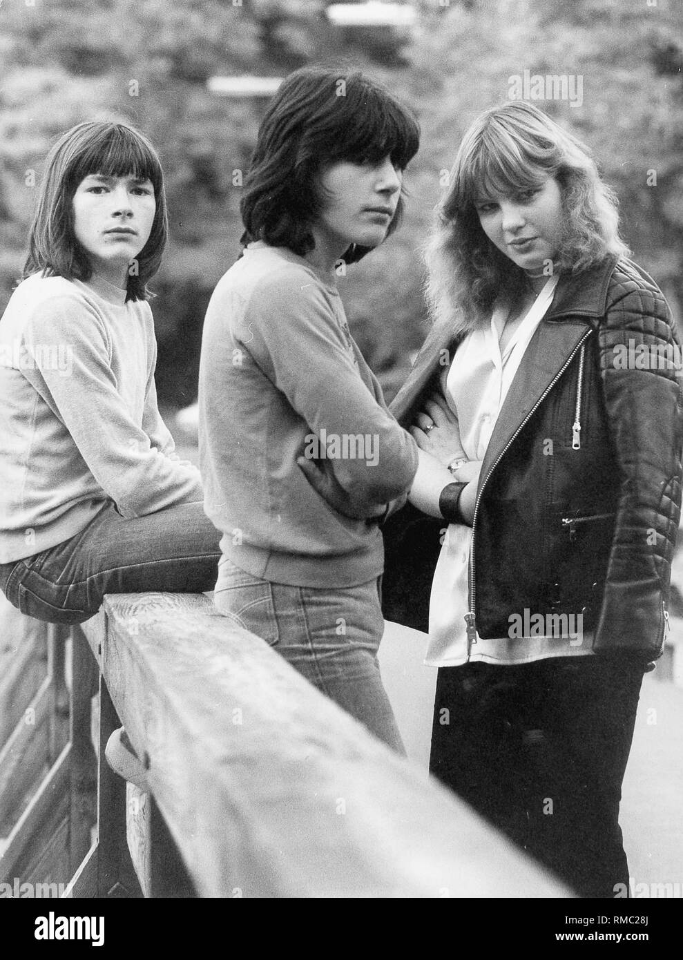 Three teenagers on a bridge Stock Photo - Alamy