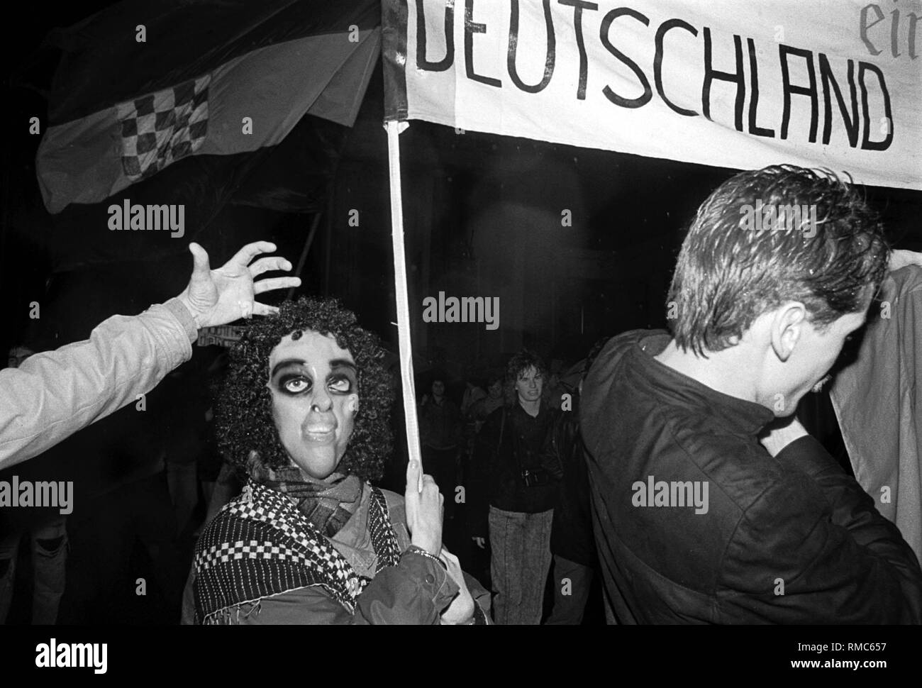 Germany, Berlin, December 22, 1989: opening of the Brandenburg Gate. Person with a mask. Inscription: 'Germany'. Stock Photo