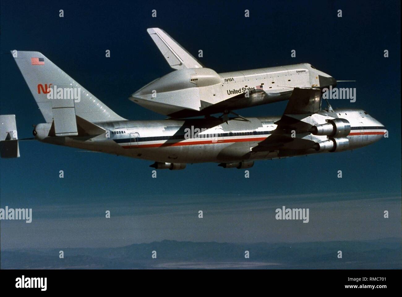 The space shuttle "Enterprise" on its first free flight. The test orbiter is given a piggyback ride into Earth's atmosphere by a carrier-based aircraft, a Boeing 747. Stock Photo