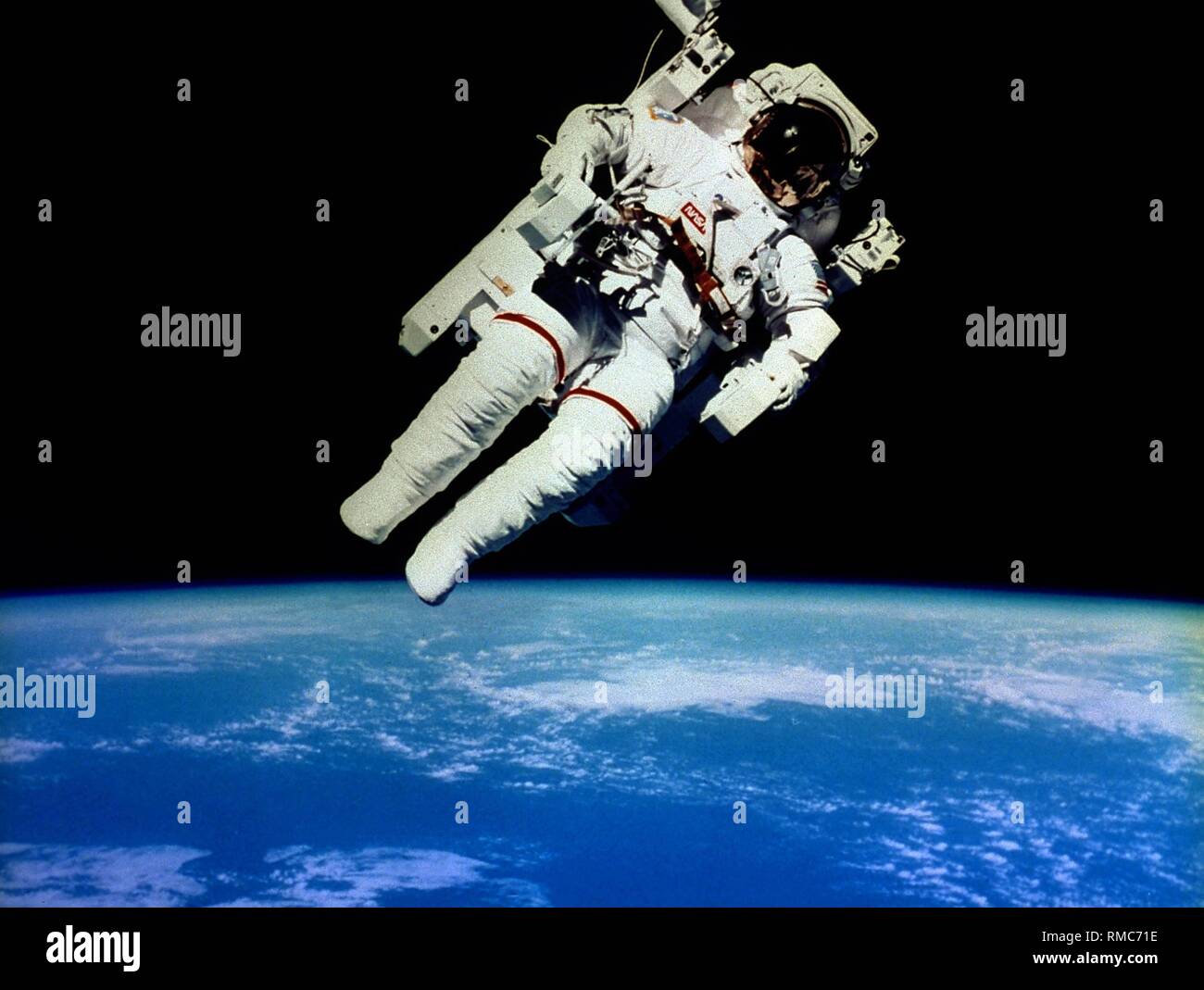 Astronaut Bruce McCandless on his exit into space during the 10th shuttle mission, the so-called  STS 41B. McCandless was the first astronaut to make his spacewalk with a Manned Maneuvering Unit (MMU) without a leash. Stock Photo