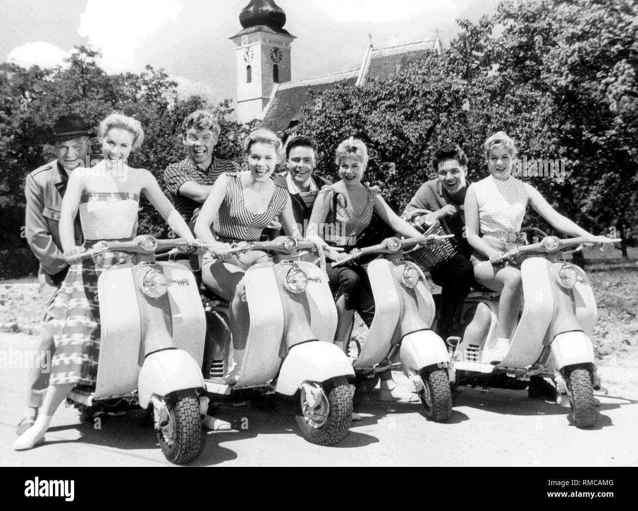 Filmstill from 'Vier Maedels aus der Wachau' with Harald Dietl, Heinz Conrads, Michael Cramer, Thomas Hoerbiger, Alice and Ellen Kessler, Isa and Jutta Guenther. They sit on scooters. Stock Photo