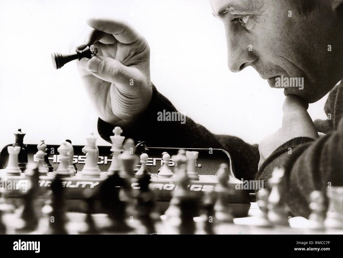 Chess, board game for two people, here concentration during the chess game with the computer 'Chess Challenger', 1981. Stock Photo
