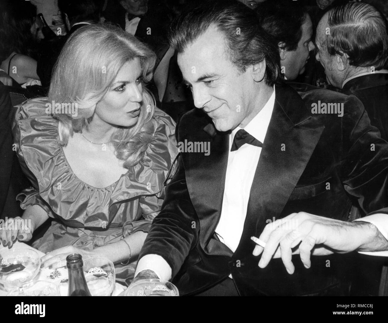 Maximilian Schell talks excited with the pretty actress colleague Christiane Krueger at the German Film Ball in 1983. Stock Photo