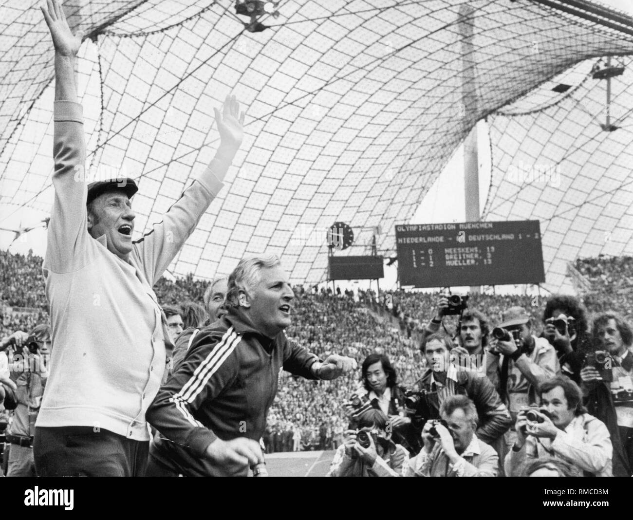 Germany wins the World Cup: national coach Helmut Schoen (l.) and Jupp Derwall cheer after the final whistle of the World Cup. Stock Photo