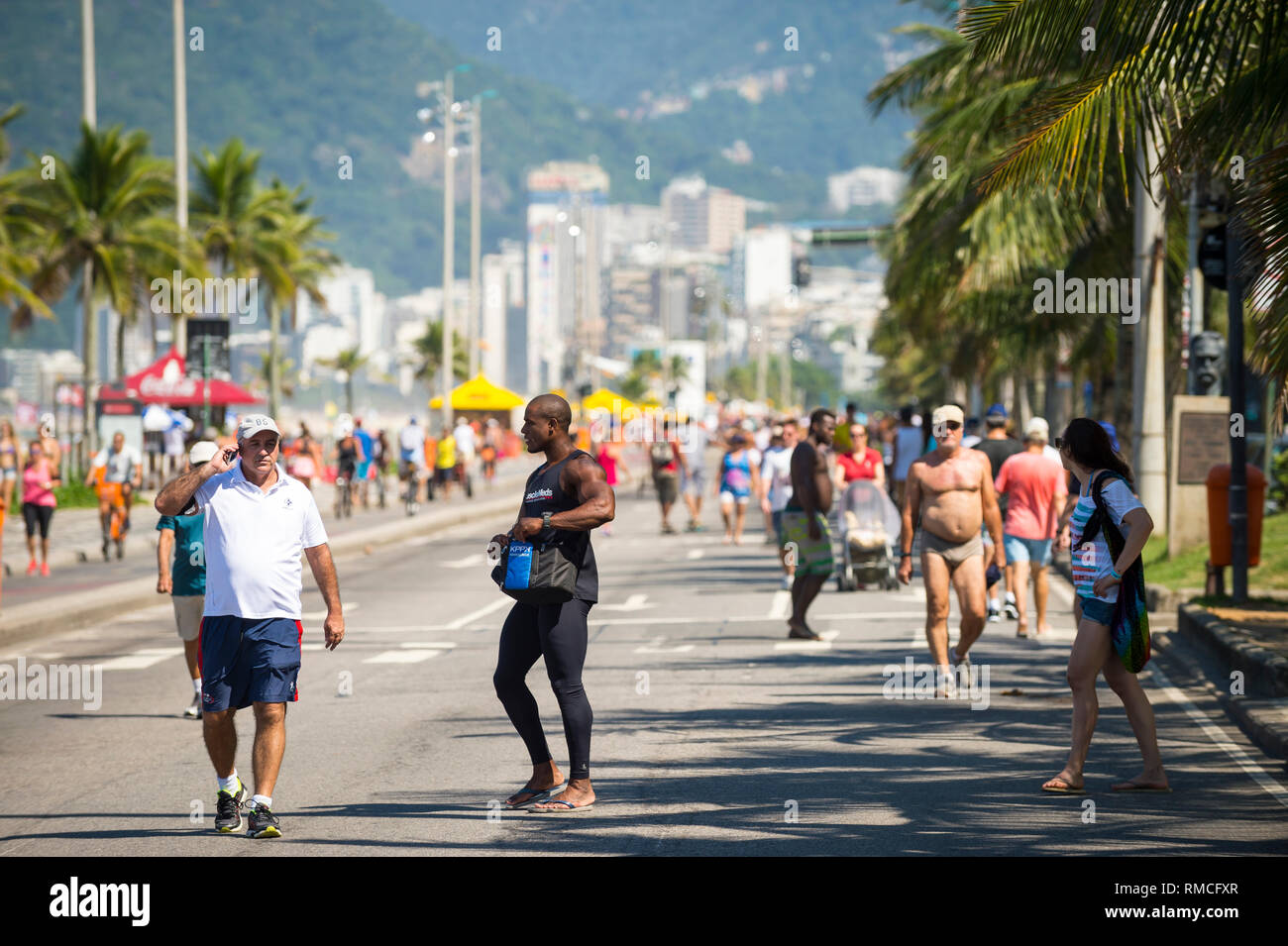 RIO DE JANEIRO - MARCH 6, 2016: Pedestrians take advantage of a car-free Sunday afternoon on the beachfront Avenida Vieira Souto street in Ipanema. Stock Photo