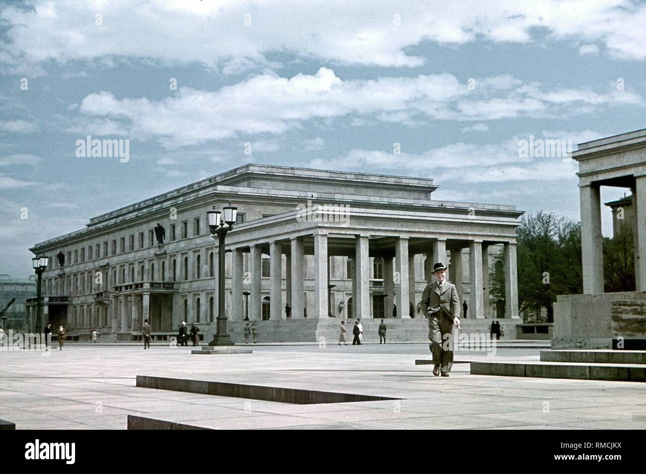 In 1935 the Koenigsplatz was remodelled after the designs of architect Paul Ludwig Troost. Here were built a so-called 'Fuehrerbau' (left) and Ehrentempels for the coffins of the Nazis killed in the Beer Hall Putsch (in the middle and on the right at the edge of the picture). The place was paved with natural stone slabs and remodelled as a square for parades. Stock Photo