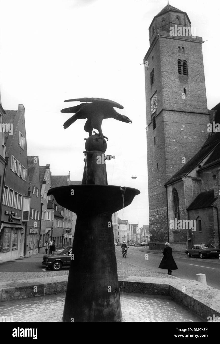 Fountain in Donauwoerth. In the background is the tower of the parish church (undated shot). Stock Photo