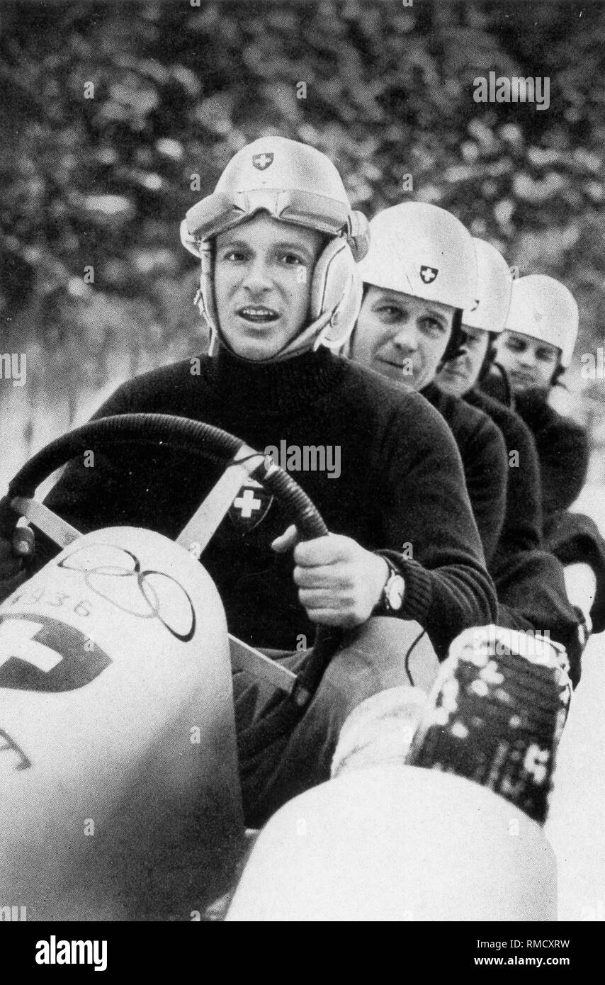 Bobsleigh at the IVth Olympic Winter Games in Garmisch-Partenkirchen: The four Swiss of the bob 'Schweiz II' with Lieutenant Pierre Musy at the wheel, winners in the four-man bobsleigh. Stock Photo