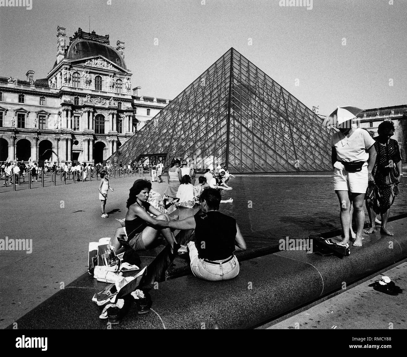 The main entrance to the Louvre leads over the 21-meter-high glass pyramid created by architect Leoh Ming Pei in the 'Cour Napoleon' in 1989. Stock Photo