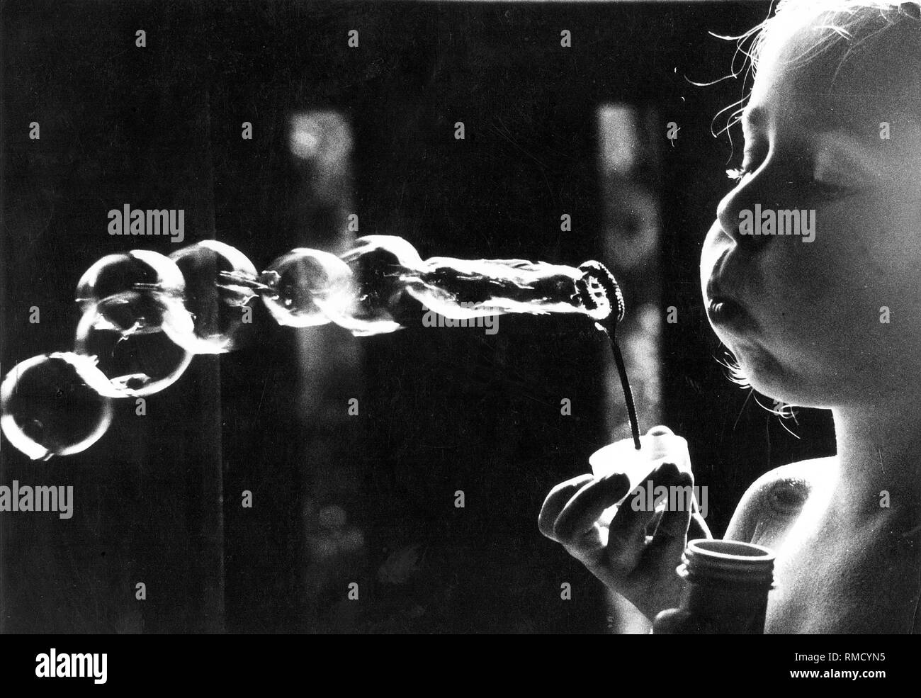 A girl blowing bubbles Stock Photo Alamy