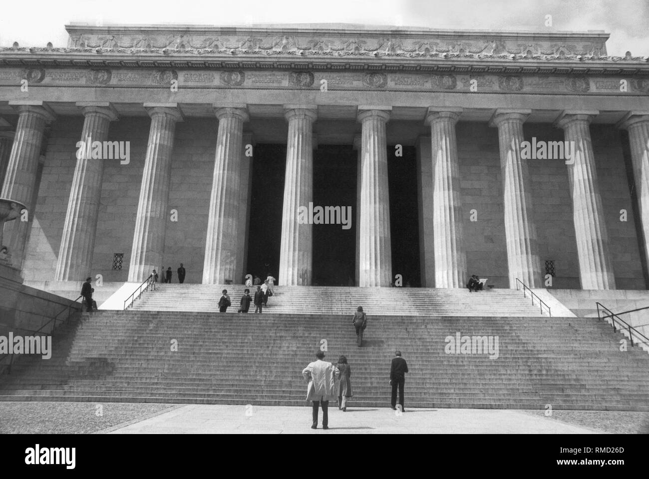 Visitors on the stairs of the Lincoln Memorial. The Lincoln Memorial was built between 1915-22 in honor of Abraham Lincoln. It is modeled after a Greek temple supported by 36 Doric columns, one for each of the US states that existed in Lincoln's time. Stock Photo