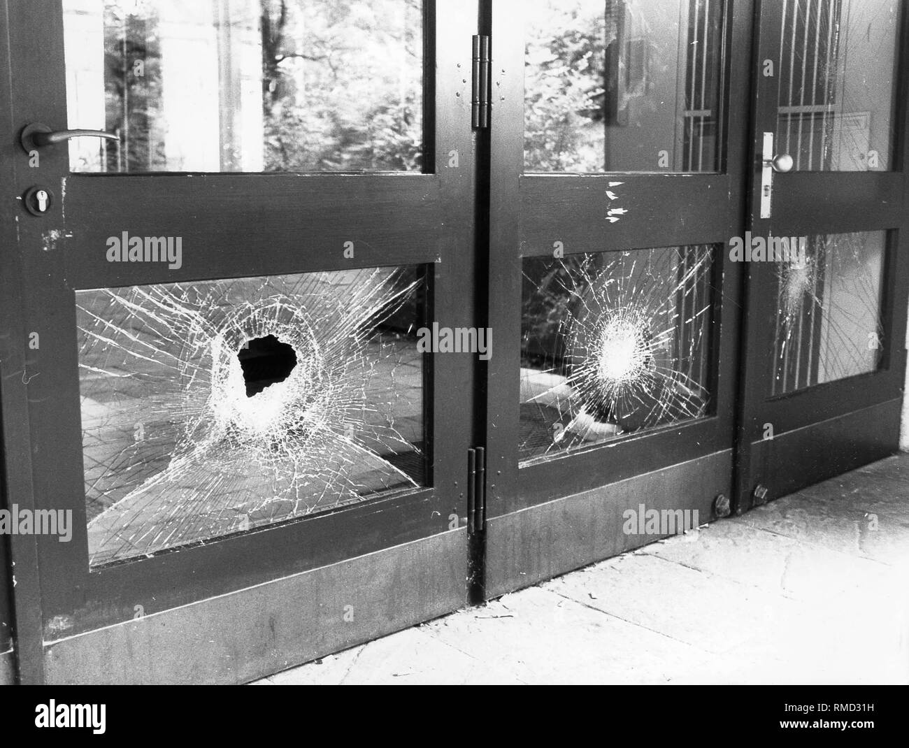 Rampaging students smashed a glass door at the Sophie-Scholl-Gymnasium in Munich. Stock Photo