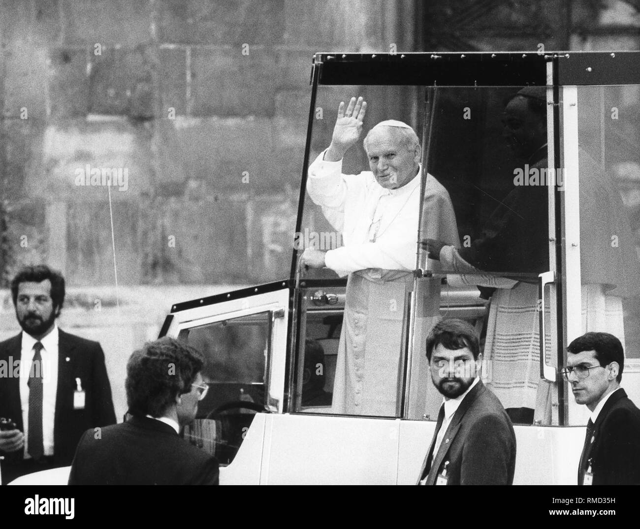 Pope John Paul II waving from his 'Popemobile' to the faithful who gathered on the occasion of his visit to Germany. Stock Photo