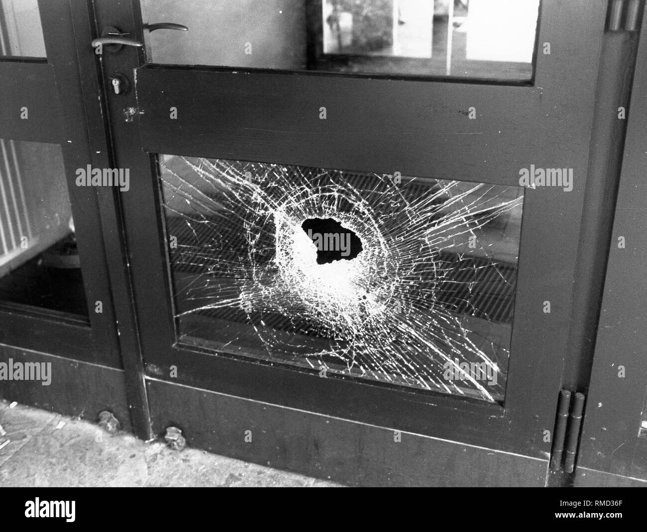 Rampaging students smashed a glass door at the Sophie-Scholl-Gymnasium in Munich. Stock Photo