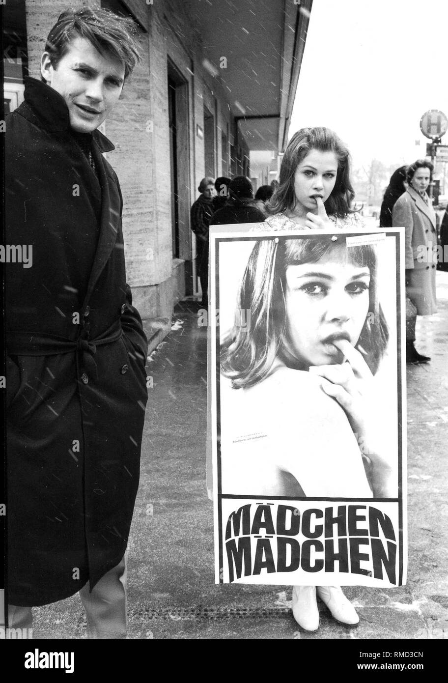 Roger Fritz (director) and Helga Anders (leading actress) with the movie poster 'Maedchen, Maedchen'. Stock Photo