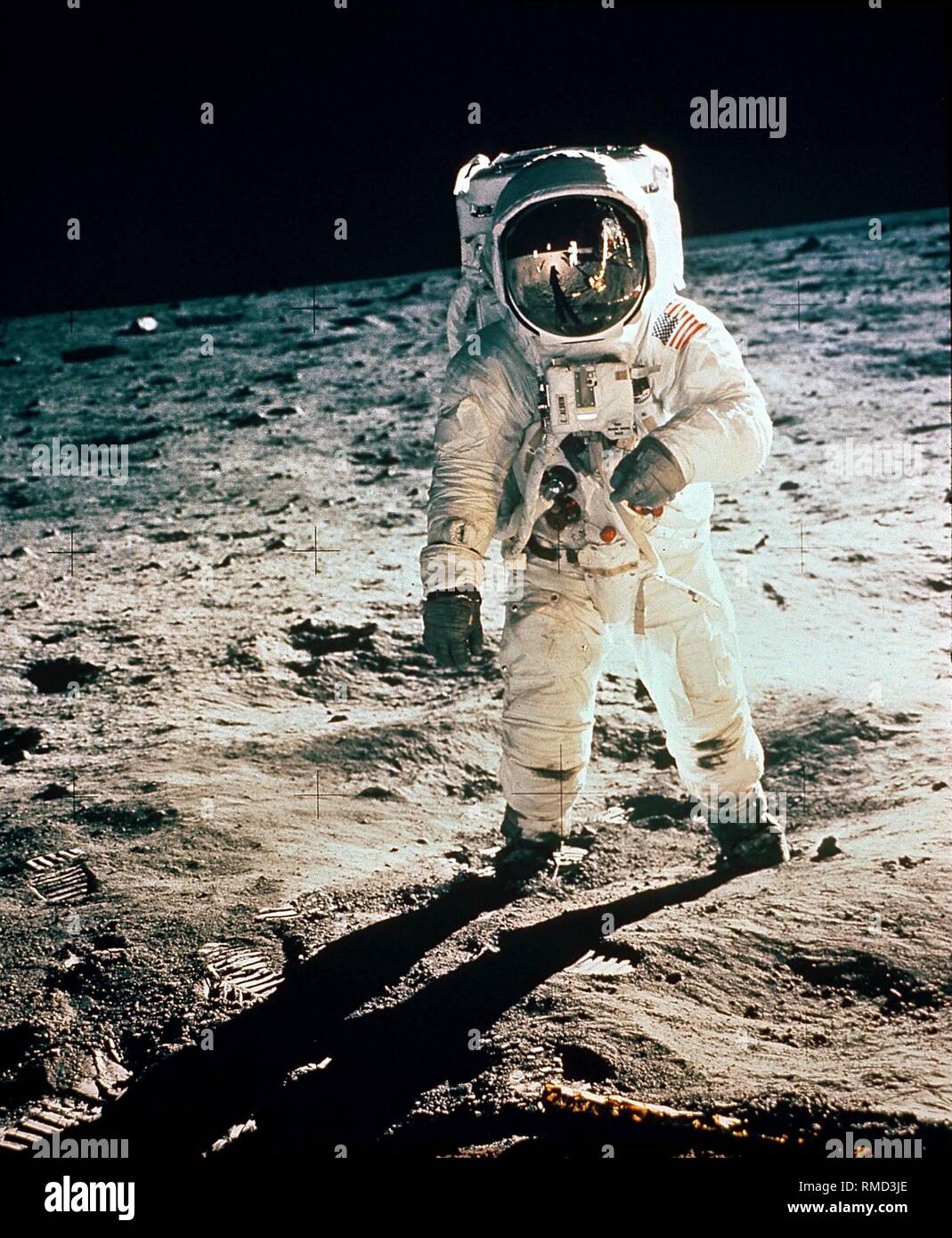 Edwin 'Buzz' Aldrin, the second man on the moon and pilot of the moon ferry 'Eagle', during his walk on the moon. His helmet reflects the moon ferry. Stock Photo