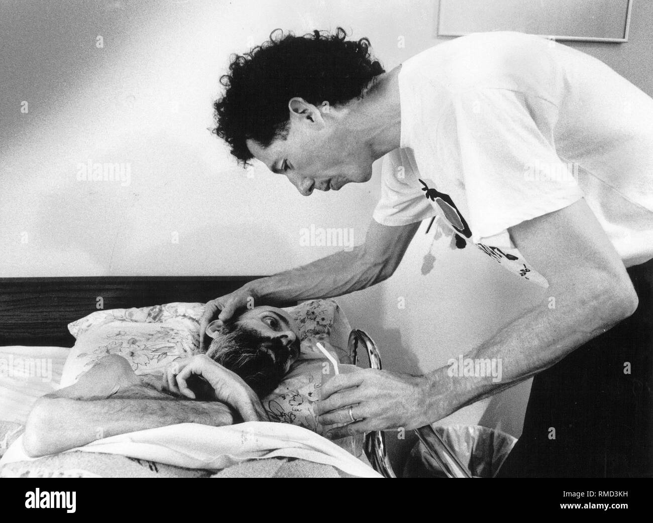 An AIDS patient is cared for by his friend at the Maitri Zen Hospice in San Francisco. Stock Photo