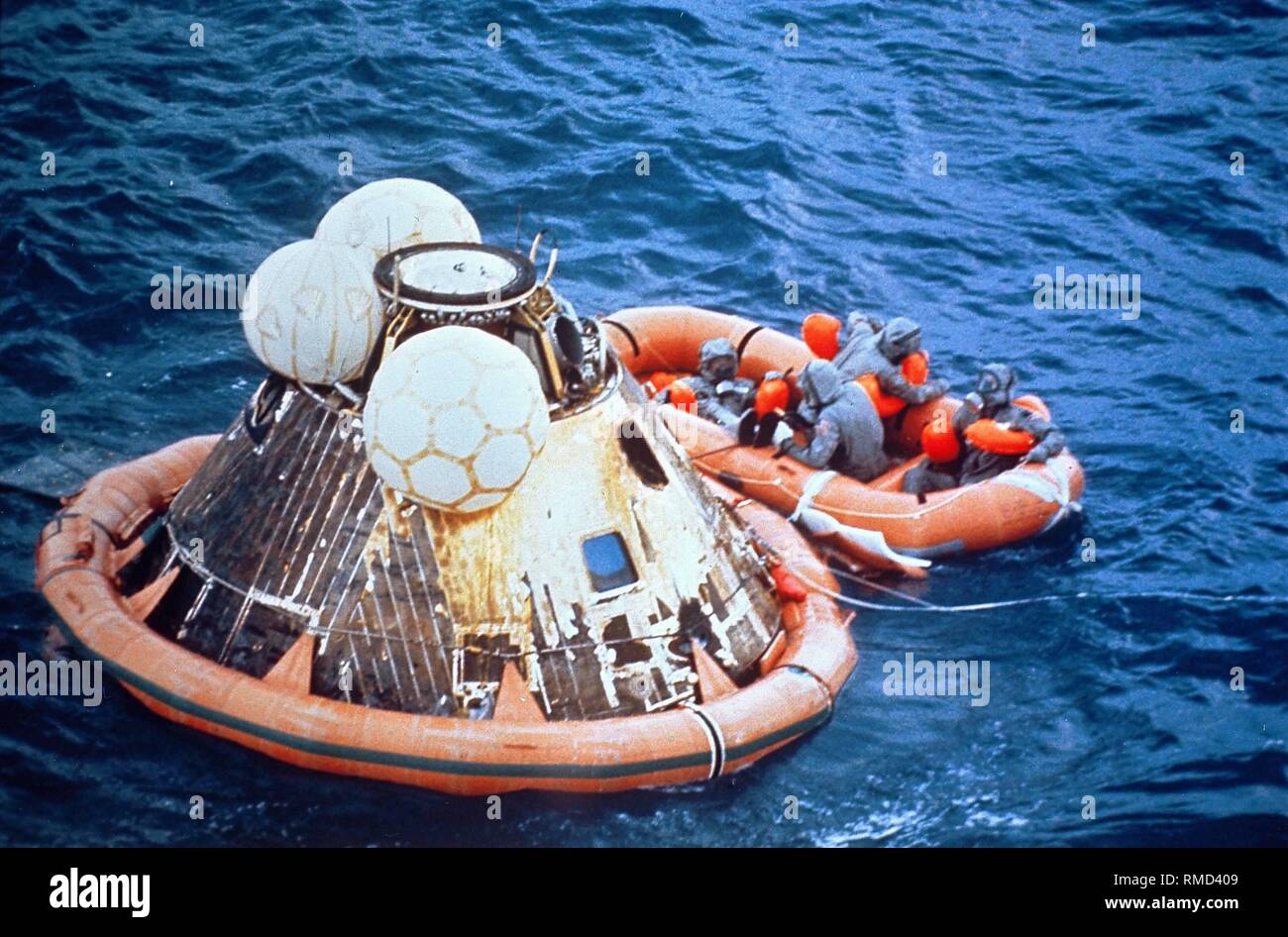 Navy divers salvage the command module of Apollo 11 with a dinghy after landing in the Pacific. Apollo 11 was the first manned Moon landing mission, and with it the most significant space mission for humanity. Stock Photo