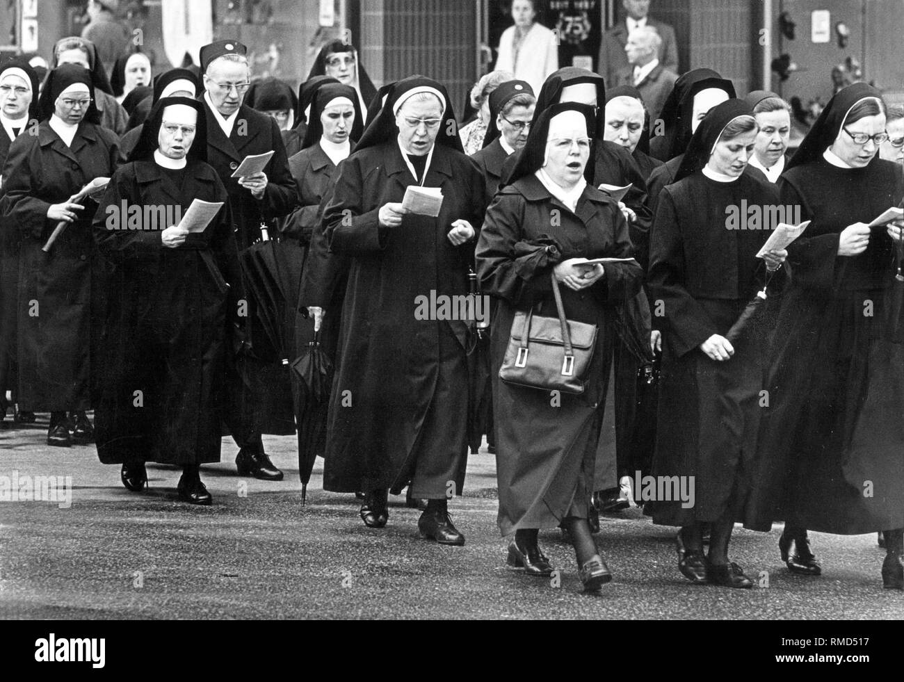 Nuns of a Catholic religious order sing in the street. Stock Photo