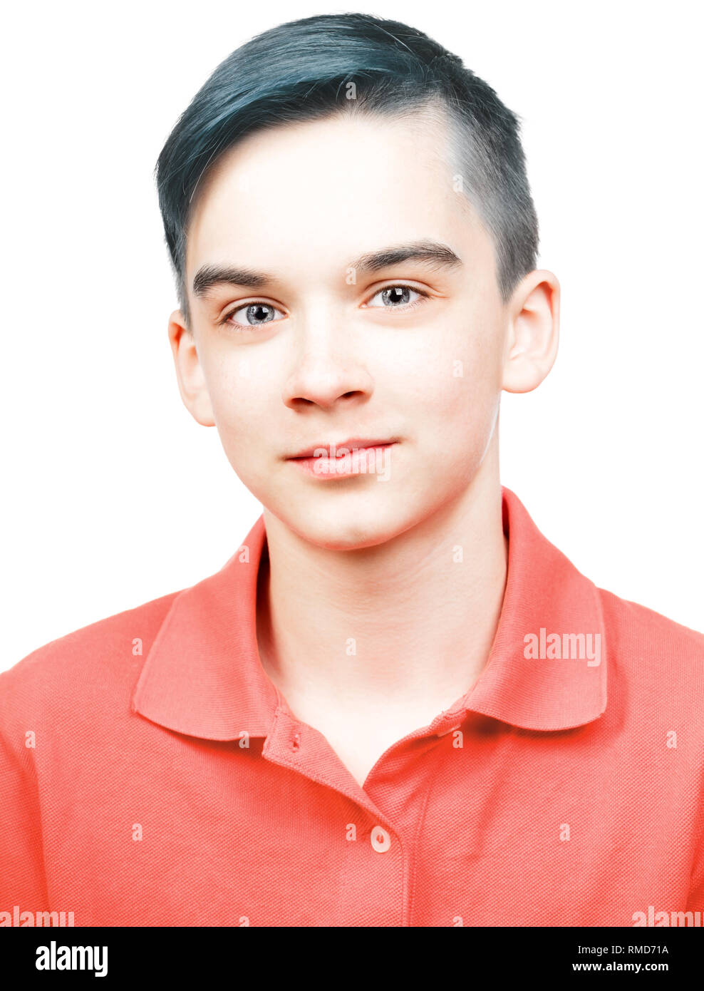 Portrait of cheerful teenager boy wearing living coral trendy color of the year 2019 polo shirt isolated on white background Stock Photo