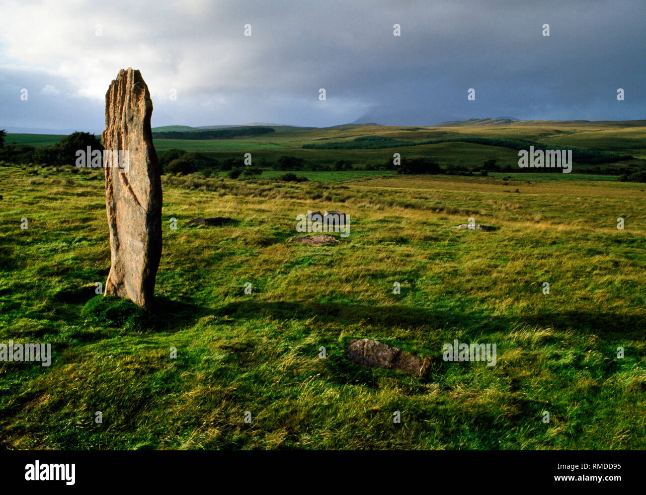 Machrie Moor stone circles, Arran, Scotland, UK: view N of the surviving sandstone pillar of Circle III with broken stumps & a partly made millstone.  Stock Photo