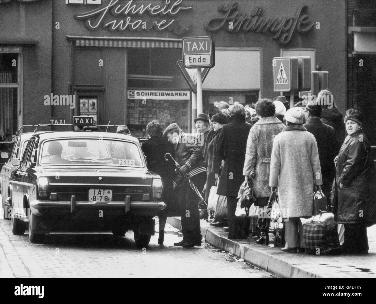 People are waiting for the few taxis at the Friedrichstrasse station. Stock Photo