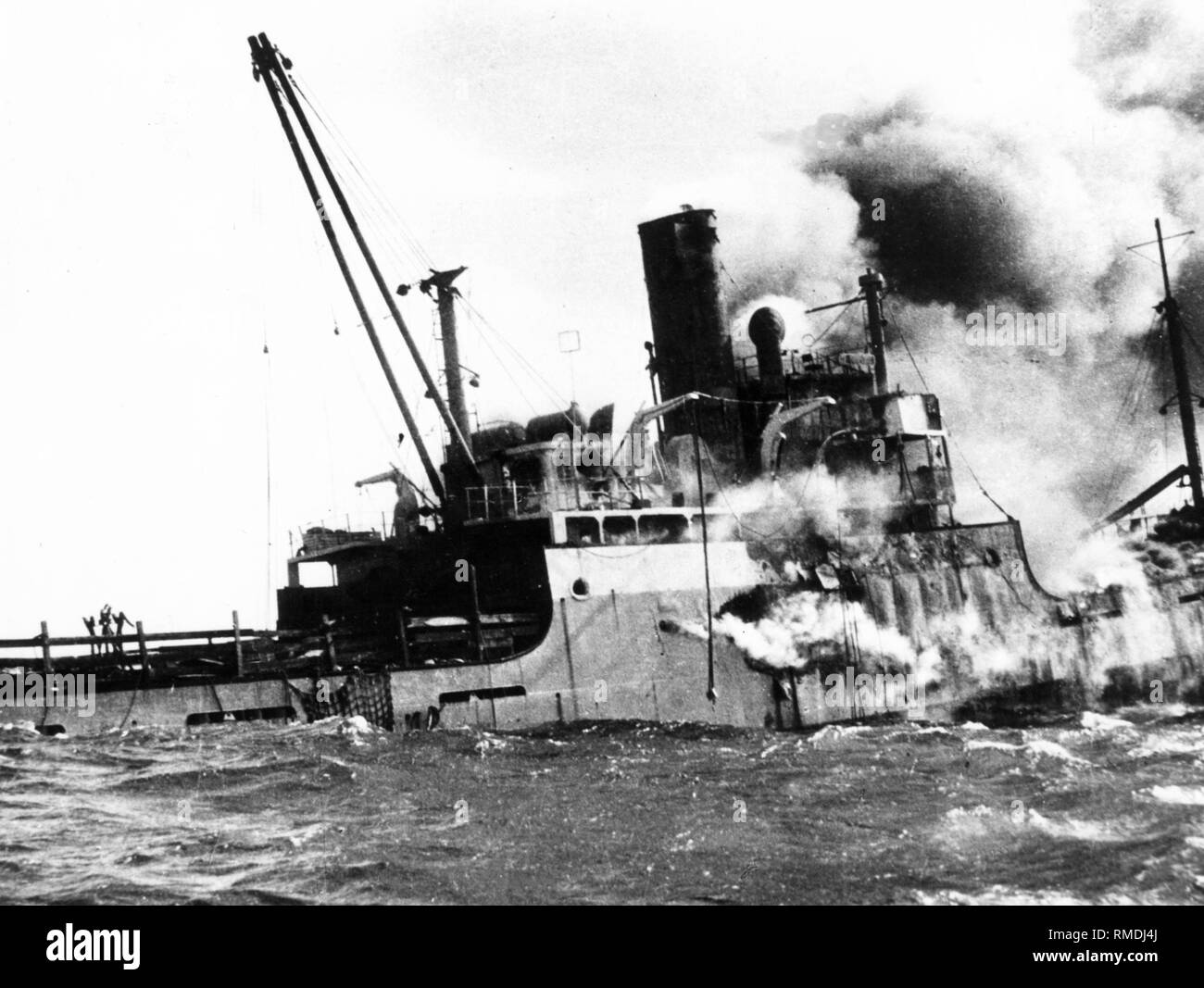 The sinking ship "Houston", which had been bombed by Castro's aircrafts, and caught fire. Most of the Cuban exiles, who were on board the transport ship, drowned in the sea. Stock Photo