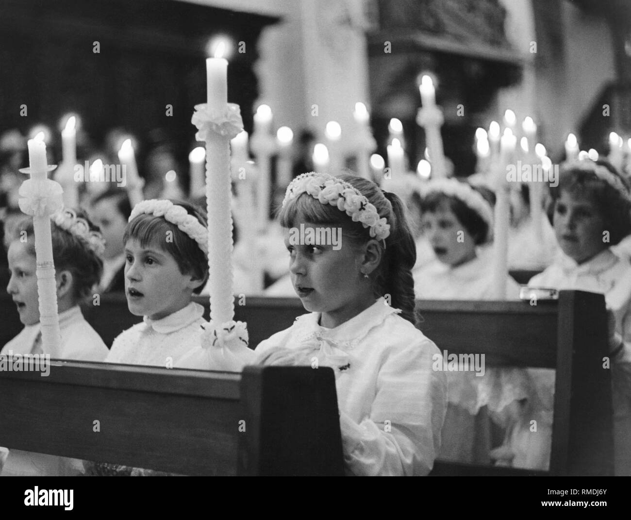 Girl during first communion service, 50s Stock Photo