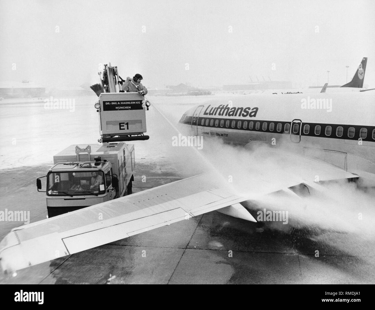 A Lufthansa Boeing 737-200 (D-ABHM 'Landshut') is being deiced at Munich Riem Airport. The D-ABHM was the second Lufthansa engine with the name 'Landshut', and it is not identical with the plane abducted in October 1977. Stock Photo