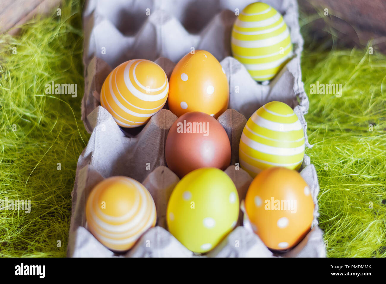 Easter composition with egg box filled with seven fake eggs and a real brown egg. Stock Photo