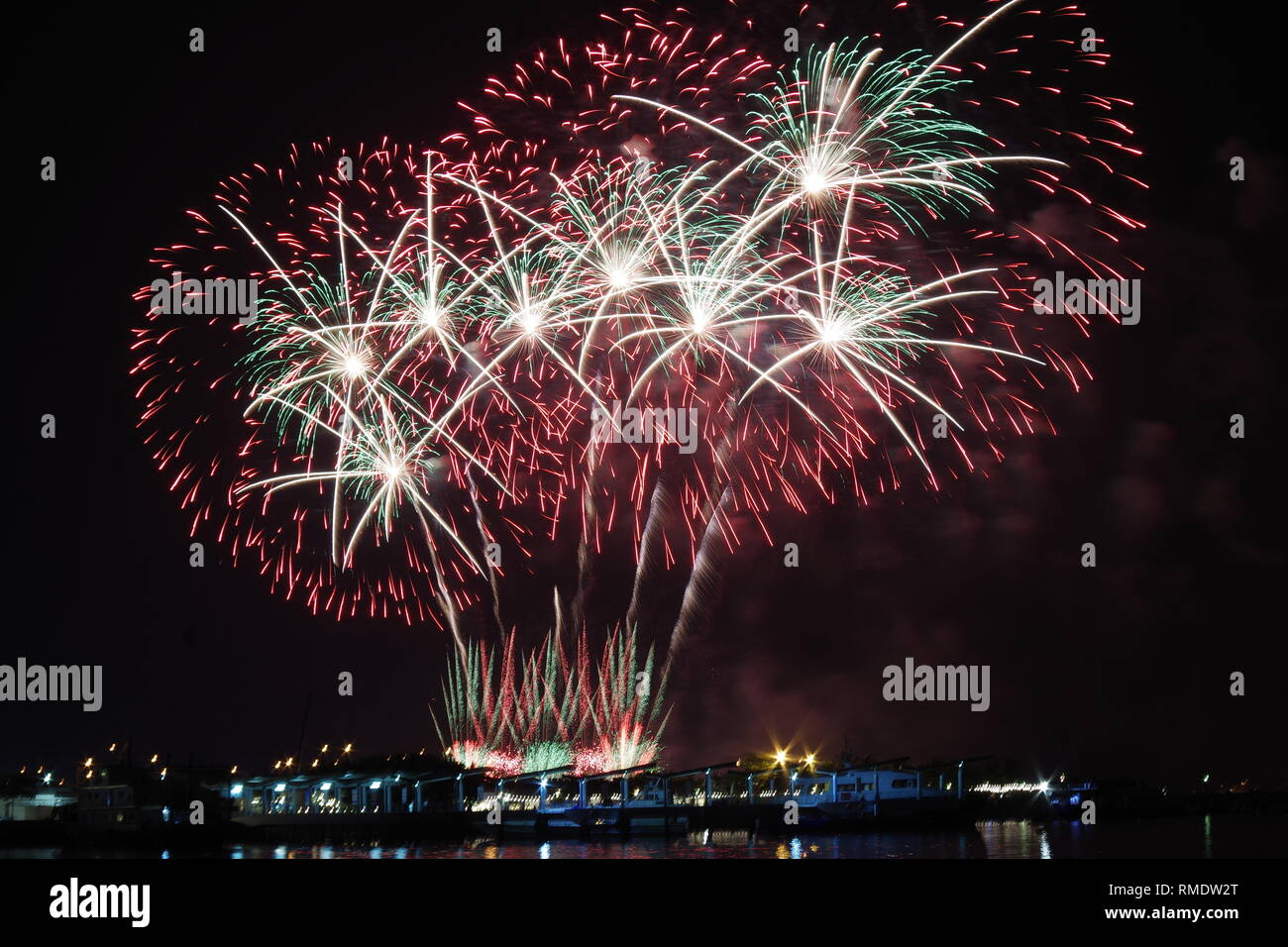 A colorful fireworks display at the bay where the sky was lit up by beautiful lights. Stock Photo