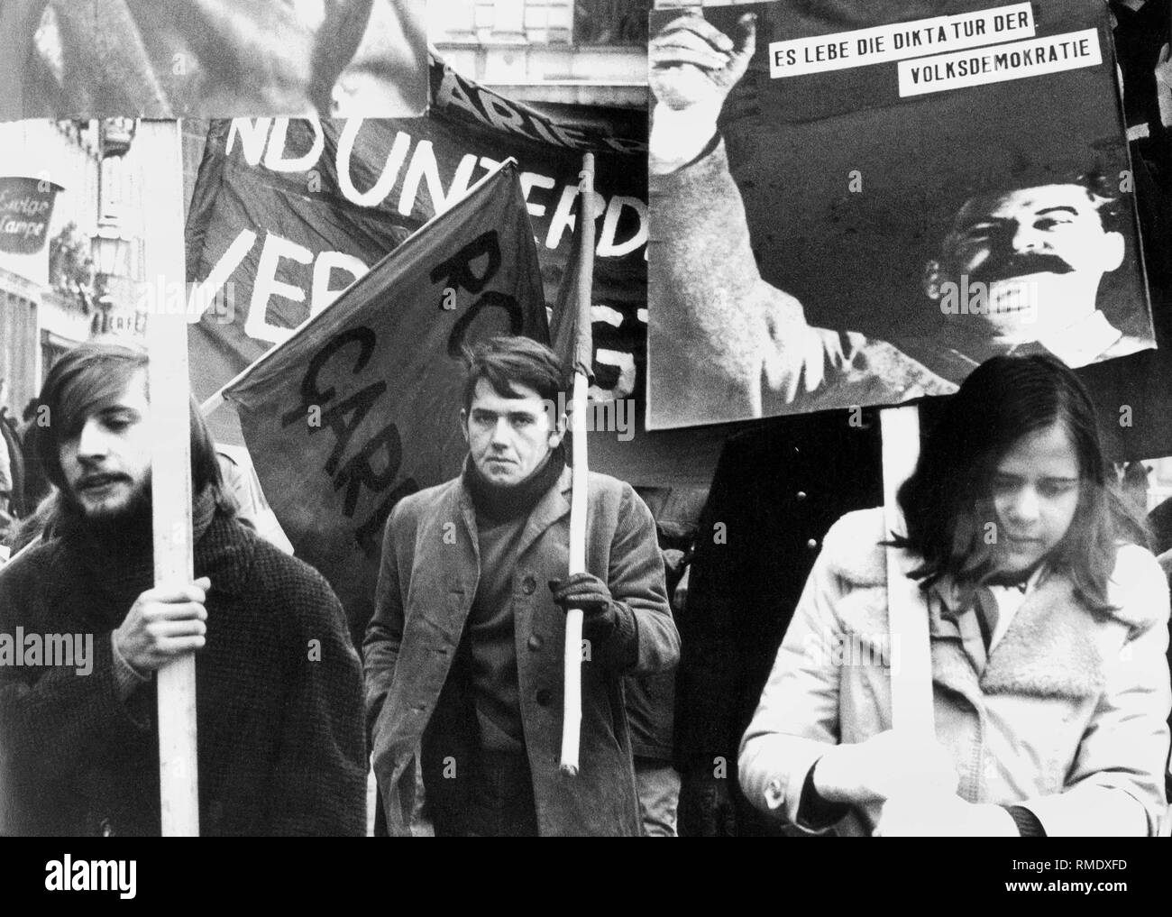 Students with banners in hands demonstrate in Munich. On the poster in front there is a portrait of Joseph Stalin. Stock Photo
