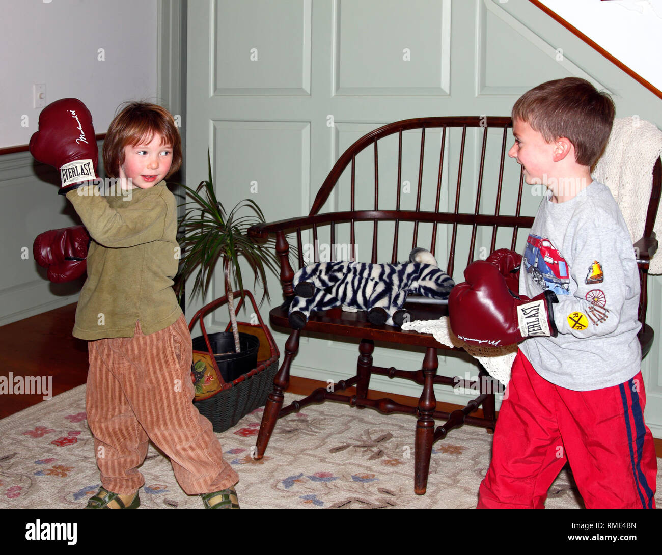 2 young boys, play boxing; boxing gloves; friends; pretend, children