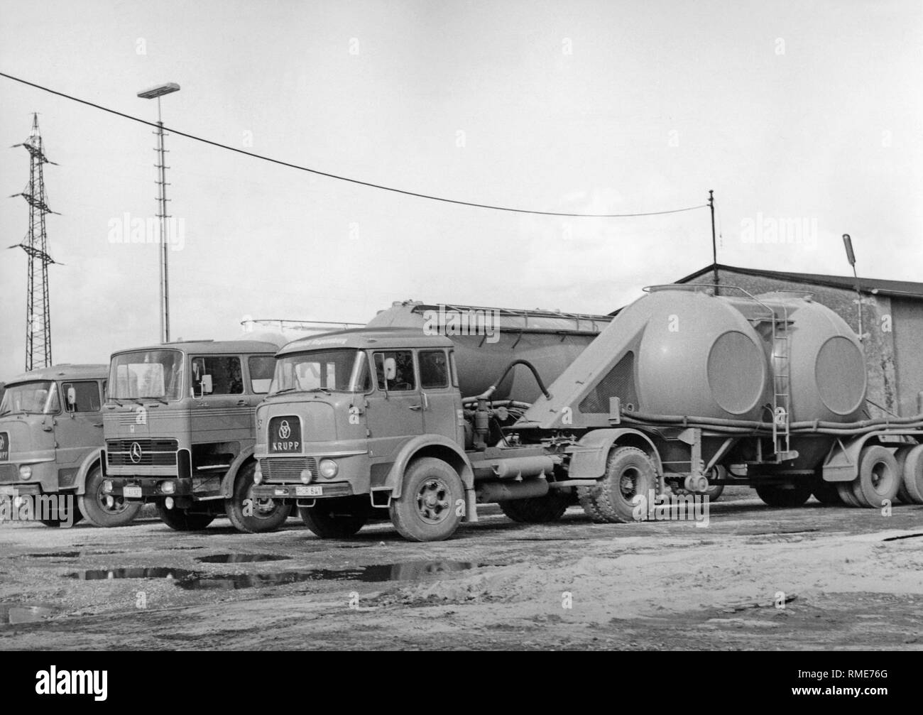 Fleet of the Spedition E. Schmidt from Regensburg. Trucks from Mercedes-Benz and Krupp with semi-trailers for transporting lime and cement. Stock Photo