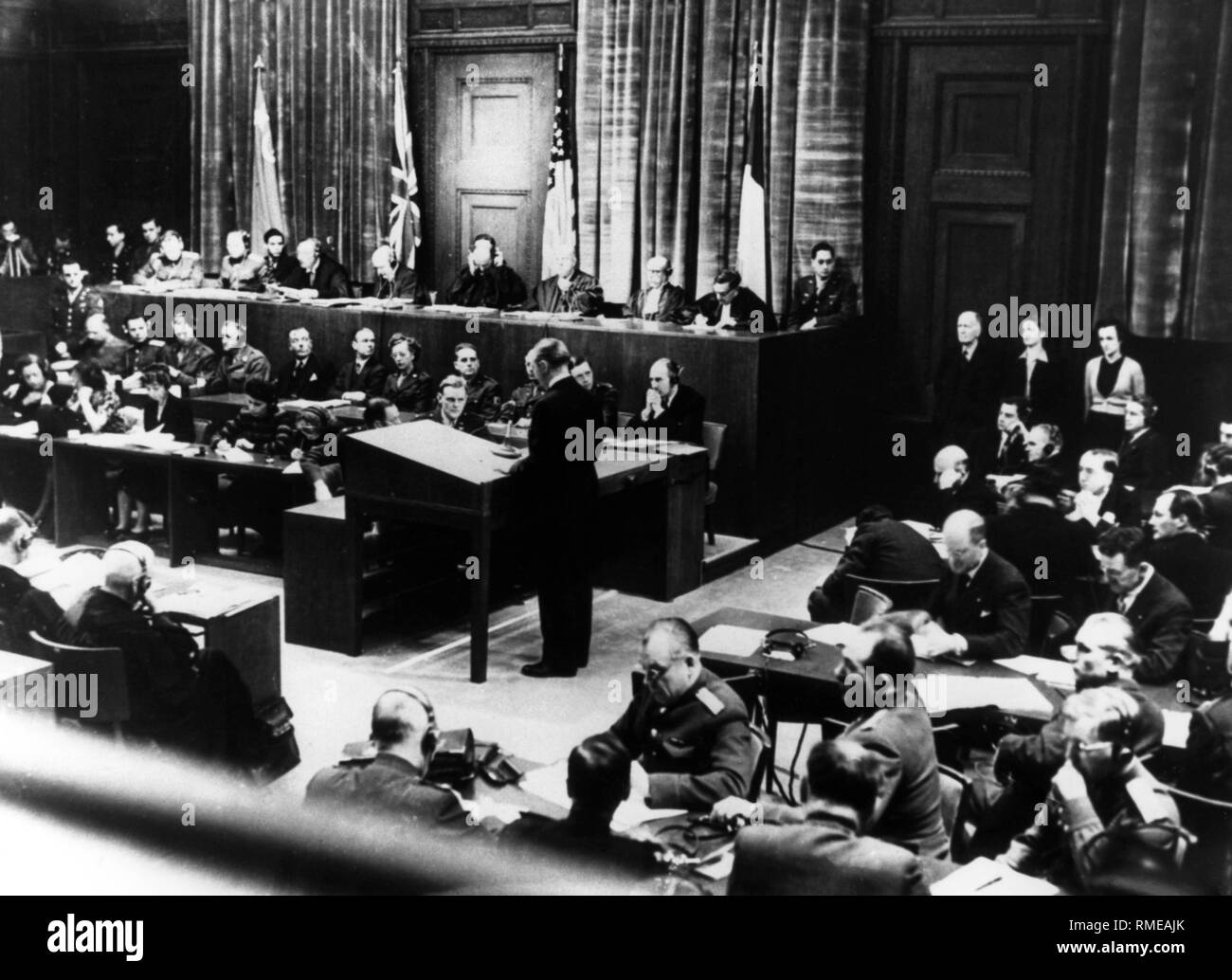 The courtroom of the Nuremberg Palace of Justice and the prosecutors during the Nuremberg war crimes trial. On the judge's tribune (background in front of the flags) from left: A.F. Volchkov, representative of the USSR, I.T. Nikitschenko, judge of the USSR, Sir Norman Birkett, Judge of the United Kingdom, Sir Geoffrey Lawrence, Presiding Judge of Great Britain, Francis Biddle, Judge of the USA, John J. Parker, Representative of the United States, Henry Dennedieu des Vabres, Judge of France, Robert Falco, Representative of France. Stock Photo