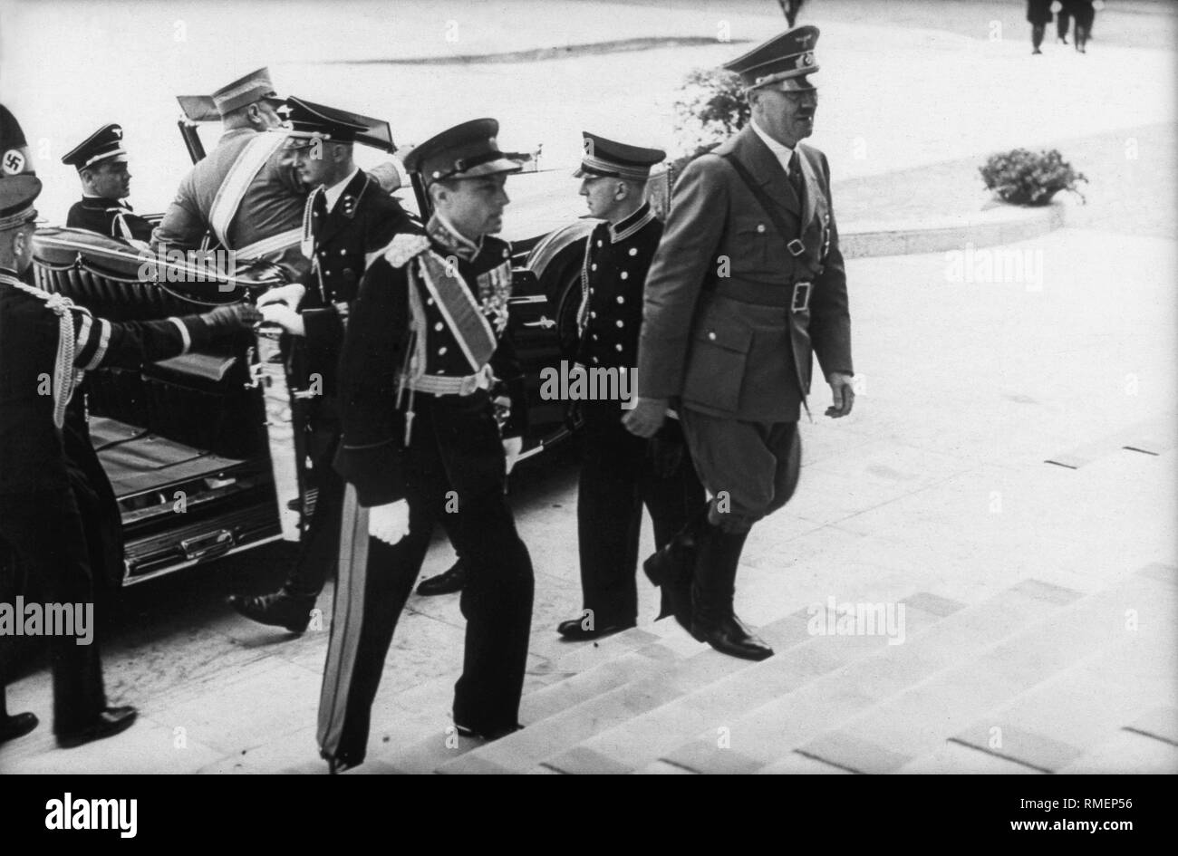 Adolf Hitler and Prince Regent Paul of Yugoslavia climb up a staircase during his visit to Berlin. In the car on the right, Hitler's adjutant Wilhelm Brueckner. Stock Photo