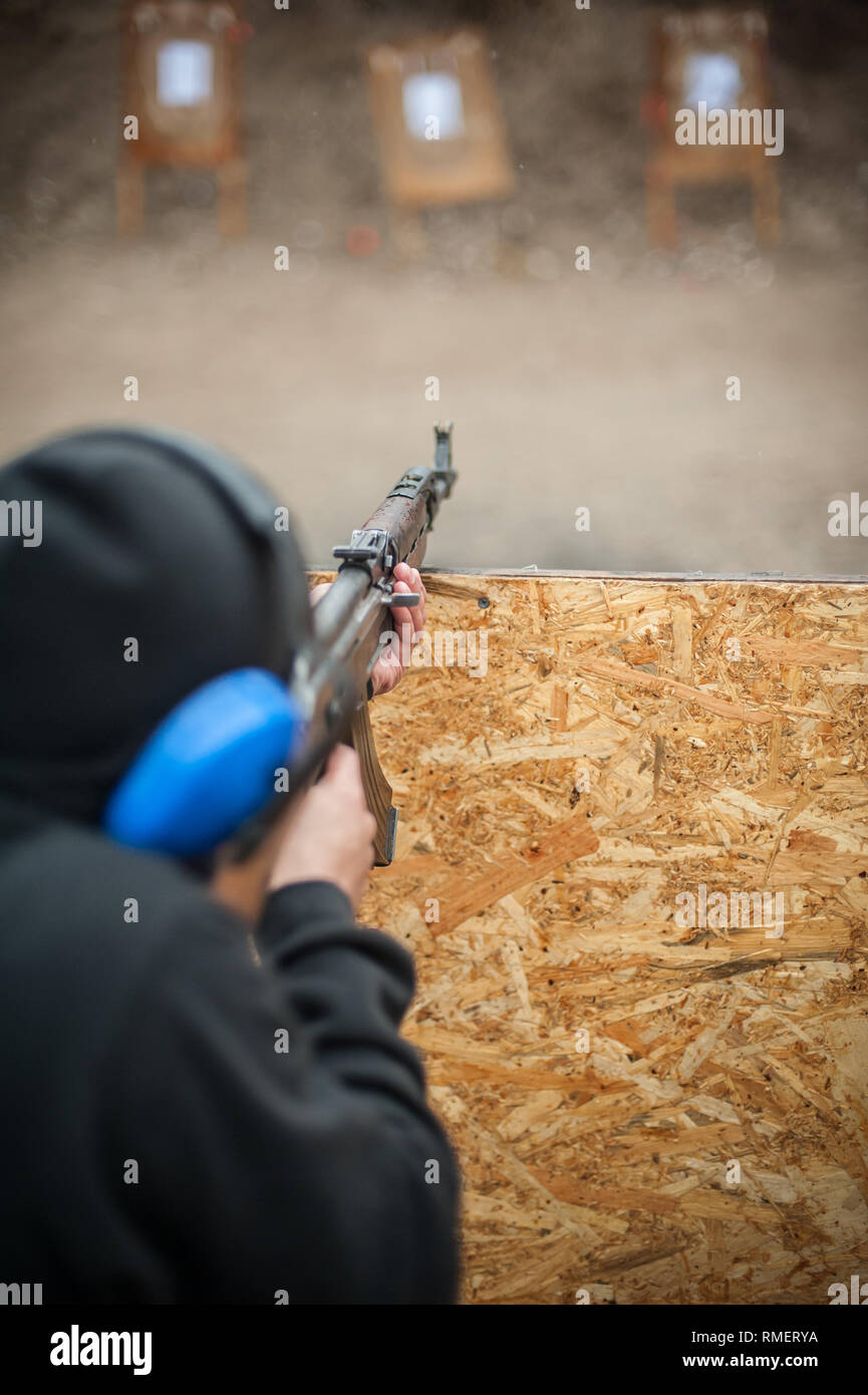 Combat riffle machine gun shooting training from behind and around