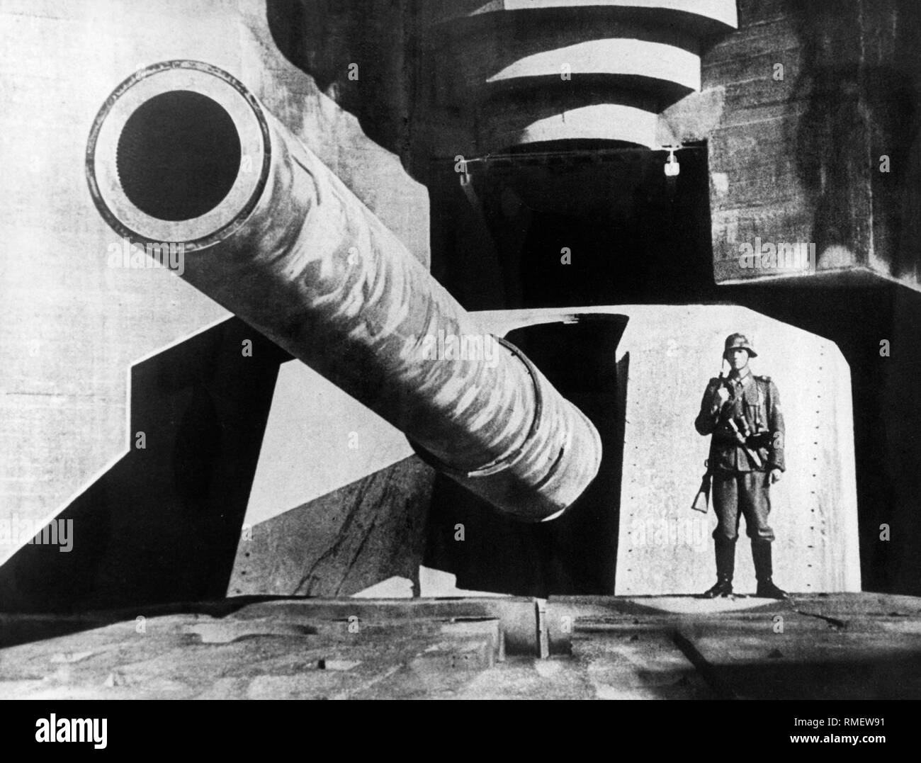 A German 38 cm coastal gun on the Atlantic Wall, next to a guard post. Stock Photo