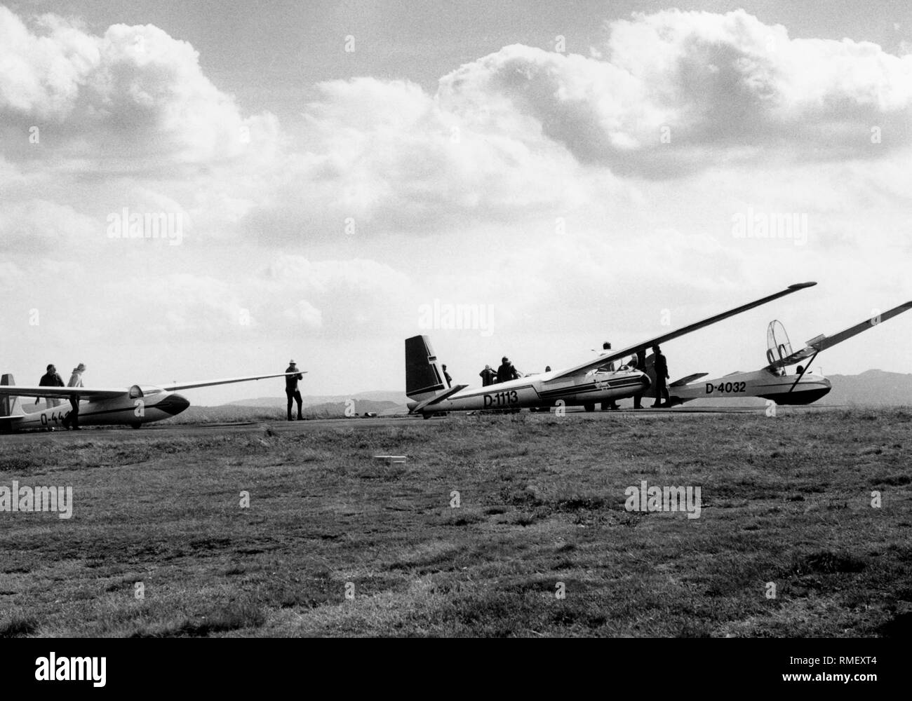 Glider pilots and planes on the Wasserkuppe in the Rhön or Rhoen Mountains. Stock Photo