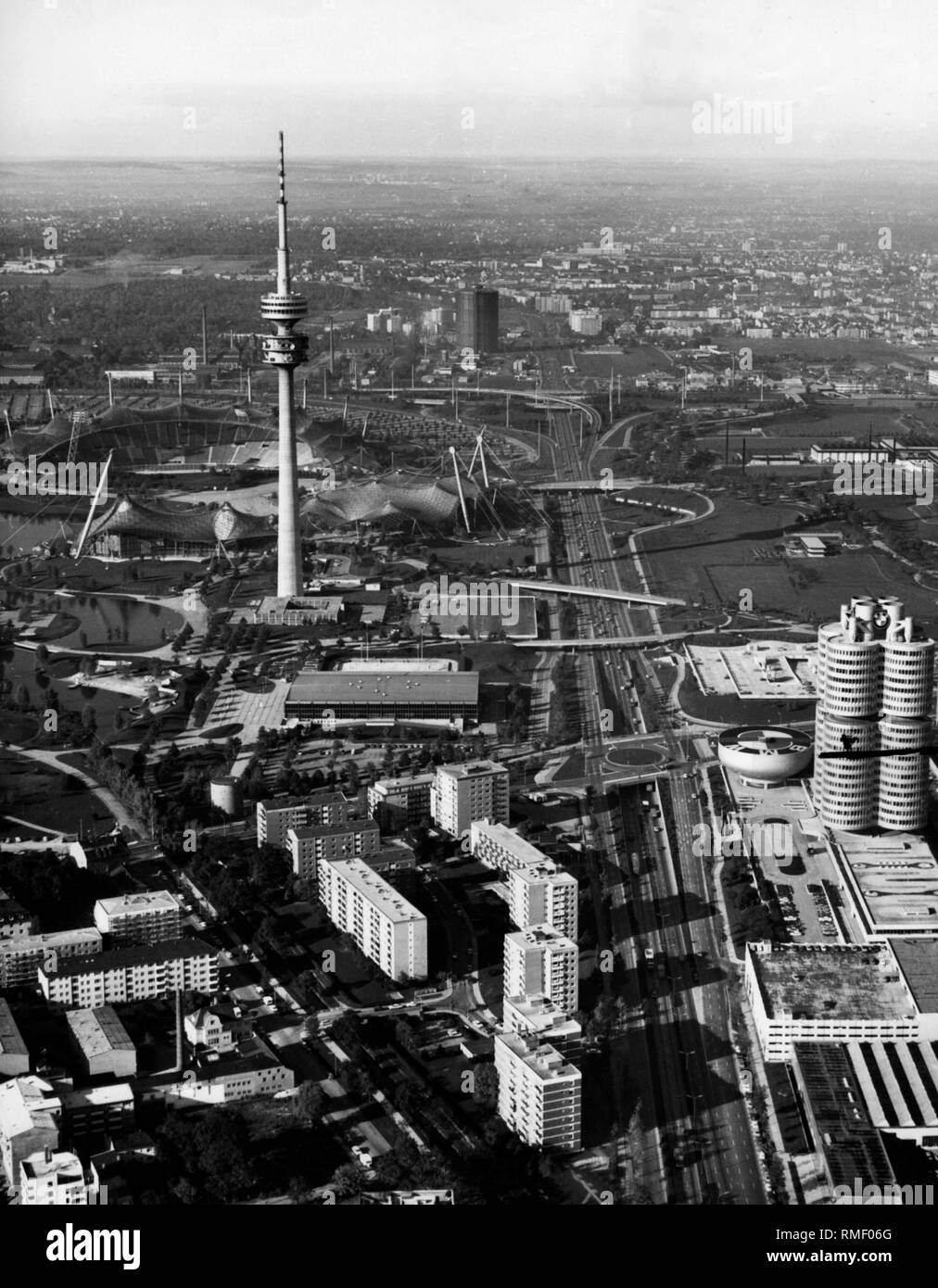 View from the east on the Munich Olympic Park with the Olympic Ice Sports Center, Olympic Tower, Olympic Hall, Olympic Swimming Pool and Olympic Stadium. On the right the BMW Headquarters and the BMW Museum. Through the middle lead the Petuelring and the Georg-Brauchle-Ring. On the left, the Biernauer Strasse and St. Blasien-Strasse. From left to right leads Lerchenauer Strasse. Stock Photo