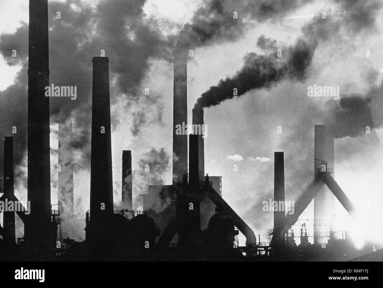 Dark clouds of smoke above the Roechling-Burbach Steel Works in Voelklingen. Stock Photo
