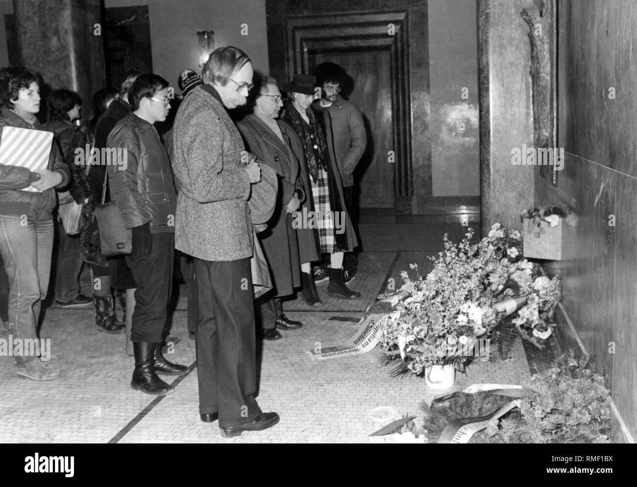 To commemorate the Scholl siblings, Franz Josef Mueller and other persons lay flowers at the memorial at Ludwig Maximilians University (undated photo). Stock Photo