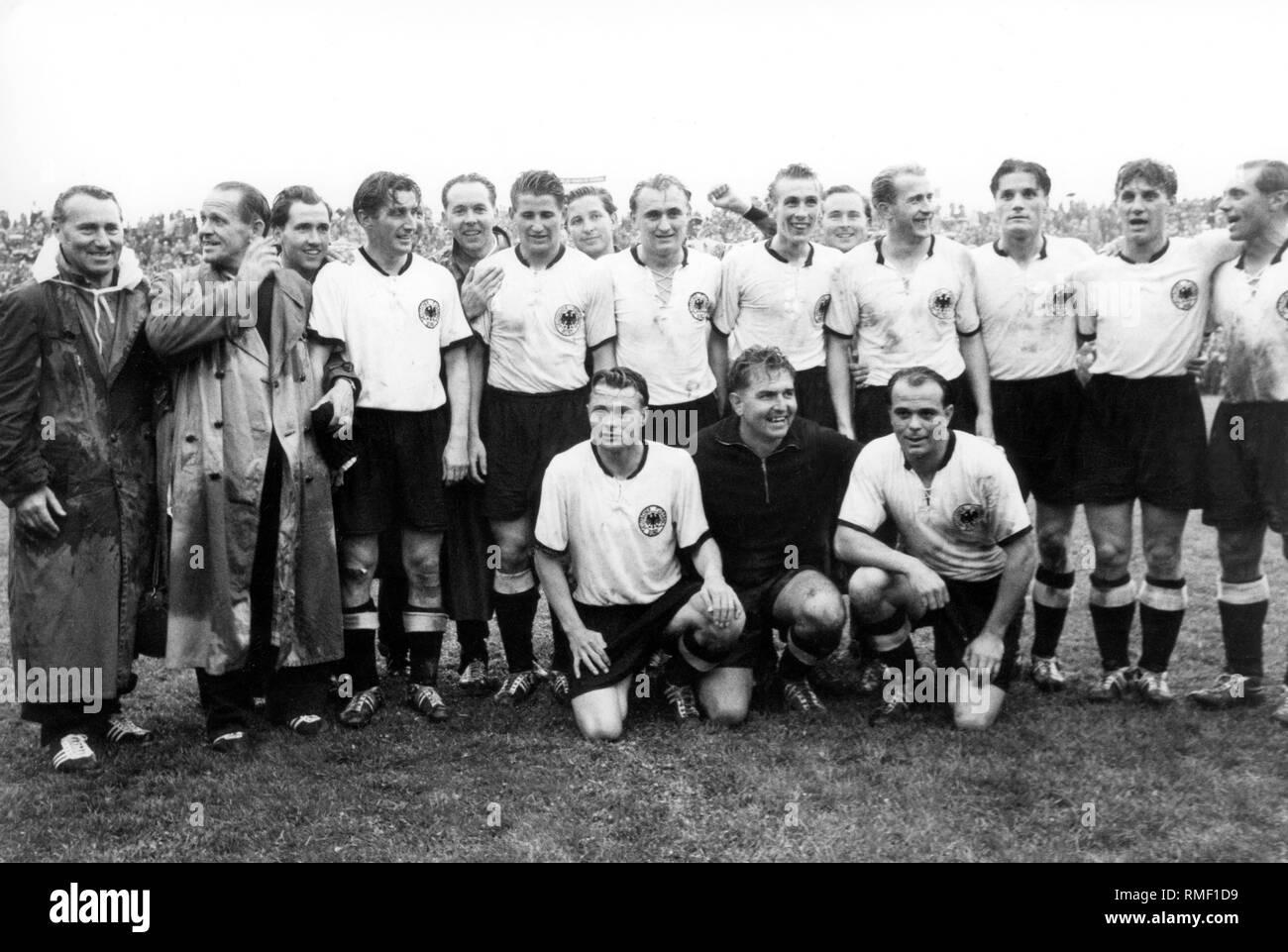 Germany is Football World Champion: At the 1954 International Football World Cup in Bern, the German national team won against Hungary with 3-2. The 'Heroes of Bern' from left: Adidas boss Adi Dassler, national coach Sepp Herberger, team captain Fritz Walter, Helmut Rahn, Josef Posipal, Horst Eckel, Werner Liebrich, Ottmar Walter, Winfried Schaefer, Max Morlock, kneeling from left: Karl Mai , Toni Turek and Werner Kohlmeyer, the only one from the triumph team of 1954, who could not see the 1974 World Cup . Stock Photo