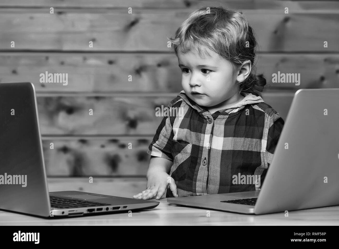 Cute boy plays on computers Stock Photo - Alamy