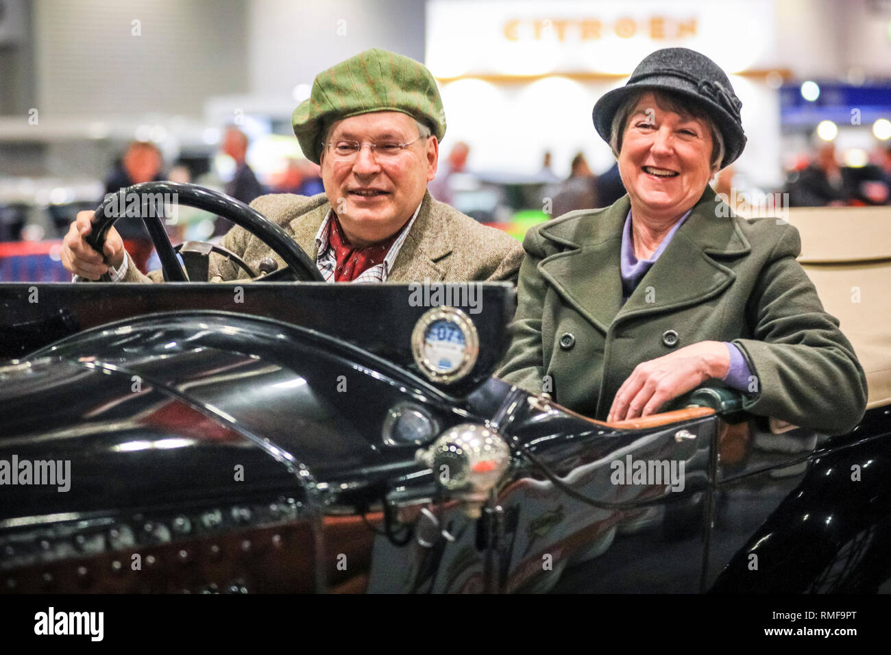 ExCel, London, UK, 14th Feb 2019.The owners of a vintage car seem delighted to race down the 'Grand Avenue' race track. The London Classic Car Show 2019 opens at ExCel Exhibition Centre in London Docklands. The show  brings together classic car owners, collectors, experts and enthusiast with dealers, manufacturers and car clubs in a celebration of motoring and classic cars. Credit: Imageplotter News and Sports/Alamy Live News Stock Photo