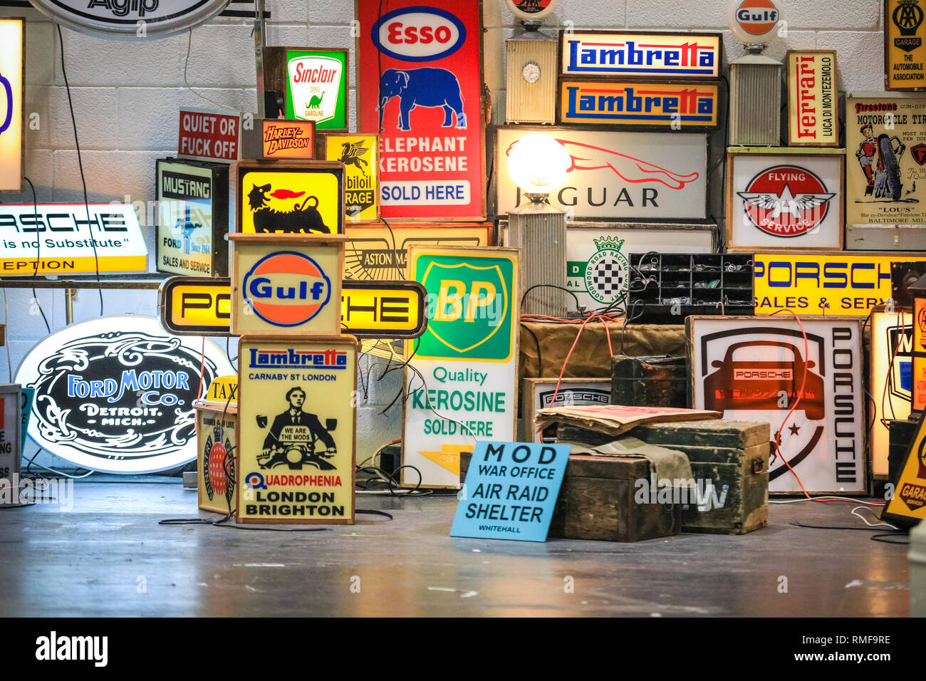 ExCel, London, UK, 14th Feb 2019. Illuminated car and petrol station signs.The London Classic Car Show 2019 opens at ExCel Exhibition Centre in London Docklands. The show  brings together classic car owners, collectors, experts and enthusiast with dealers, manufacturers and car clubs in a celebration of motoring and classic cars. Credit: Imageplotter News and Sports/Alamy Live News Stock Photo