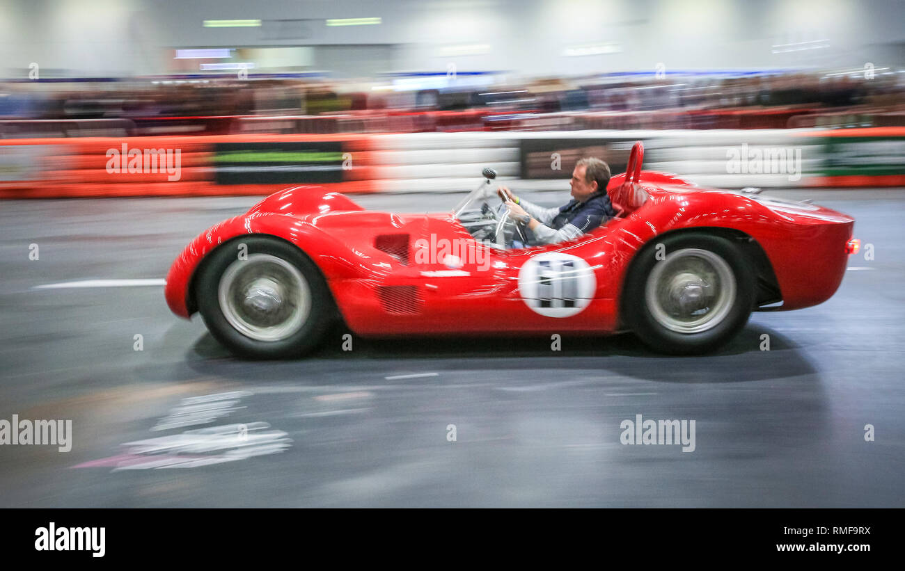 ExCel, London, UK, 14th Feb 2019. A Maserati Birdcage zooms down the Grand Avenue race track. The London Classic Car Show 2019 opens at ExCel Exhibition Centre in London Docklands. The show  brings together classic car owners, collectors, experts and enthusiast with dealers, manufacturers and car clubs in a celebration of motoring and classic cars. Credit: Imageplotter News and Sports/Alamy Live News Stock Photo