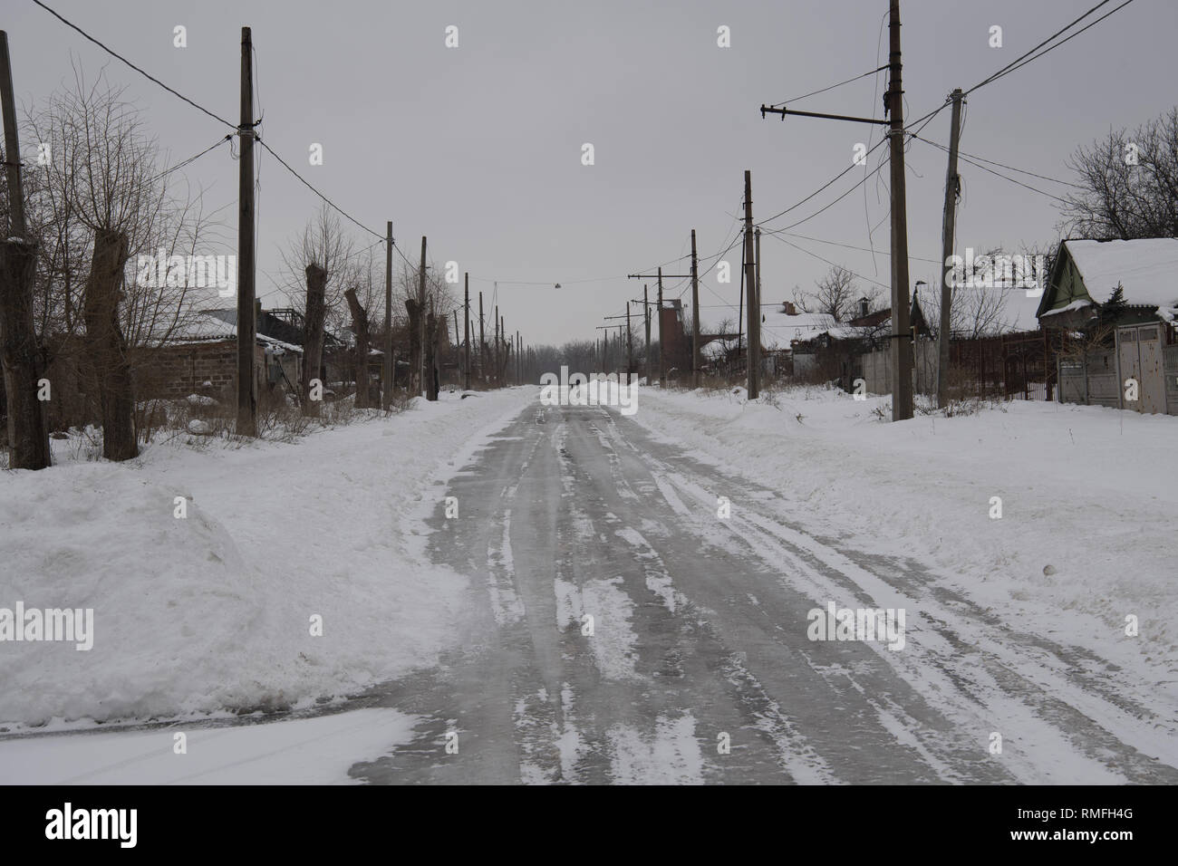 January 12, 2019 - Donetsk, Donetsk Peoples Republic (DPR) D, Ukraine - An abandoned road by most families since the shelling is so frequent it's close to the front-line.The war between the Ukrainian army and the soldiers of the Donetsk Peoples Republic has cost the lives of 12,000 people and those who have been displaced exceed a million. It escalated in 2014. Despite a ceasefire in place, it is evident that death still occurs from predominantly, sniper, mortar and mines.The construction of trenches either side of no-man's land, (often only 100mt apart) have ensured a static yet aggressiv Stock Photo
