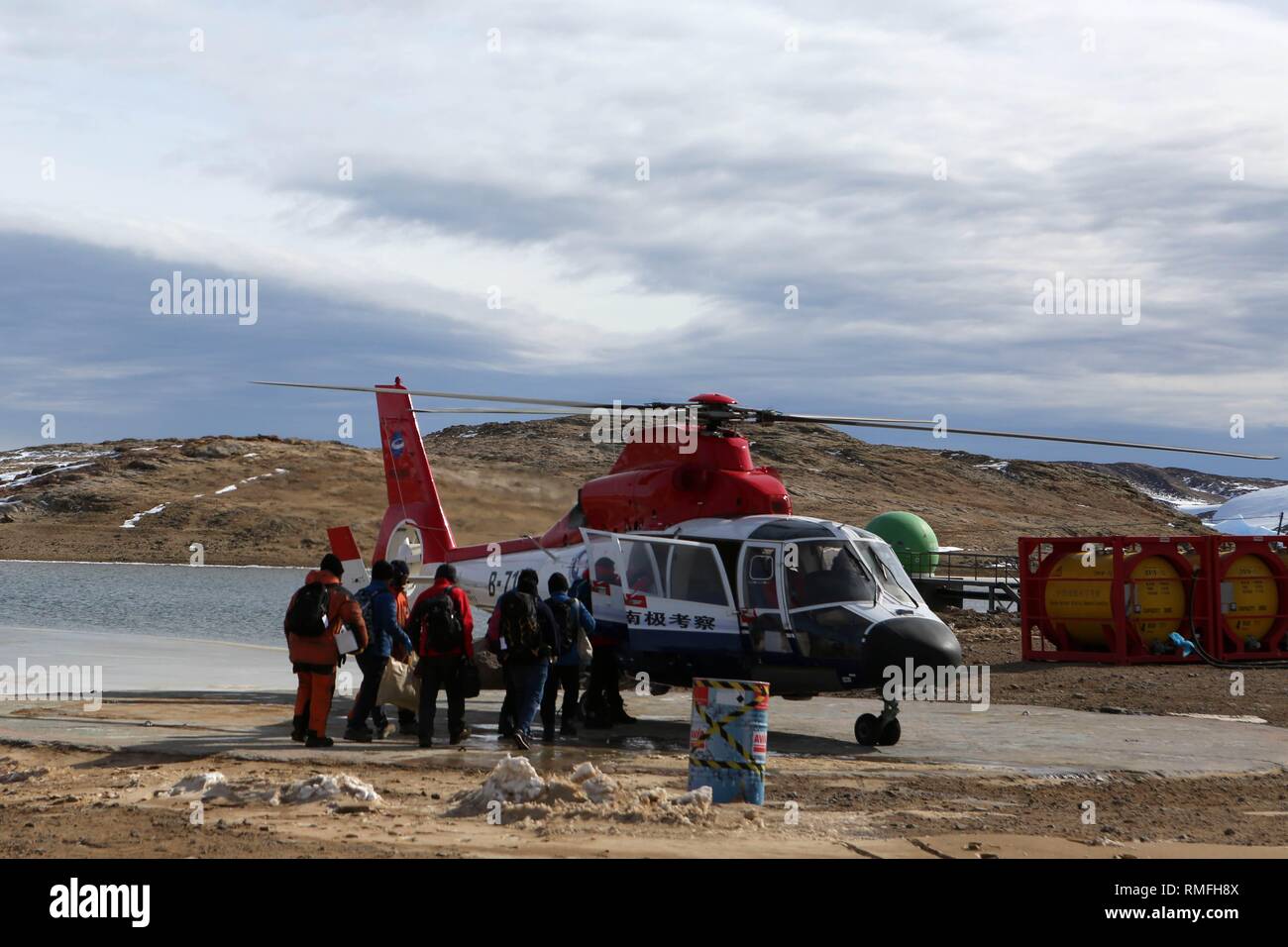 Aboard Xuelong. 13th Feb, 2019. A helicopter picks up members of China's 35th Antarctic expedition team from the Zhongshan Station to China's research icebreaker Xuelong, Feb. 13, 2019. China's research icebreaker Xuelong, with 126 crew members aboard on the 35th Antarctic research mission, on Thursday local time left the Zhongshan Station on its way back to China. Snow Eagle 601, China's first fixed-wing aircraft for polar flight, on Thursday night also departed from the Antarctic after completing all assignments. Credit: Liu Shiping/Xinhua/Alamy Live News Stock Photo